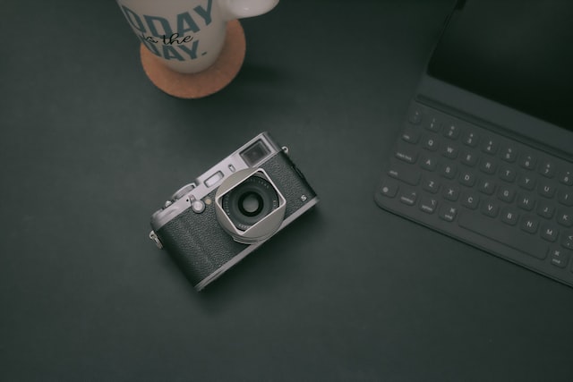 black and gray camera on table near tablet