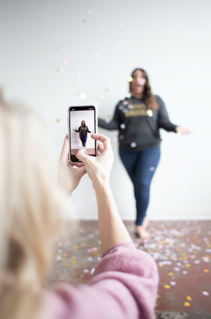 person holding white smartphone taking photo