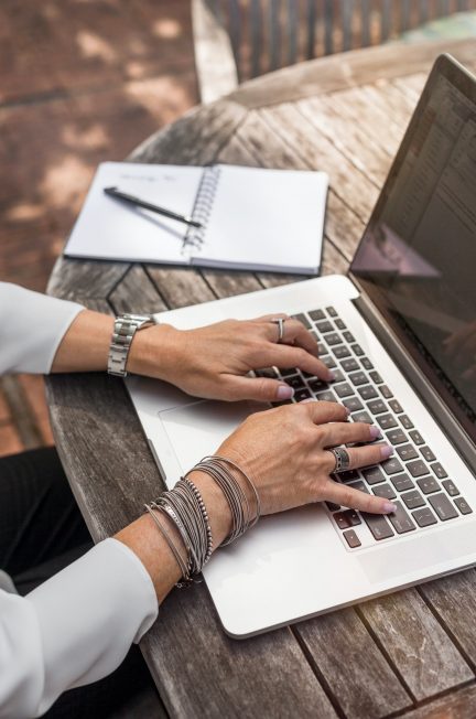 person typing on macbook