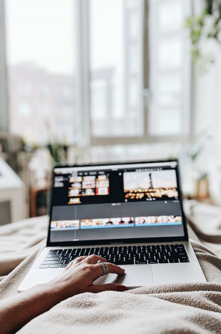 person using silver laptop inside bedroom